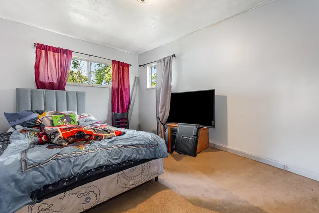 a bedroom with a bed and a flat screen tv