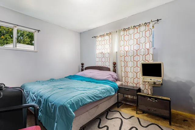 a bedroom with a bed and a flat screen tv