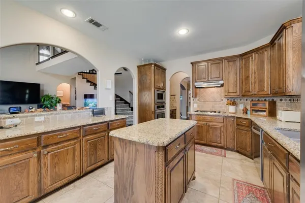 a view of living room with granite countertop furniture and a flat screen tv