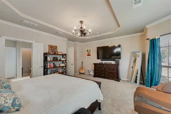 a bedroom with furniture and a chandelier