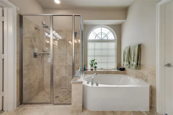 a spacious bathroom with a double vanity sink and a mirror