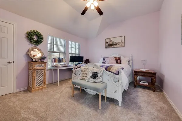 a living room with furniture a flat screen tv and a refrigerator