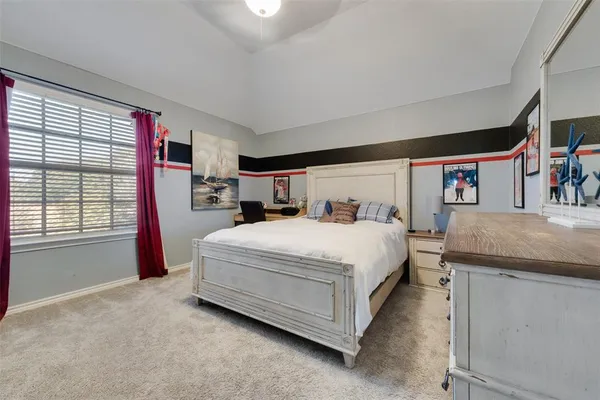 a spacious bedroom with a bed and a large window
