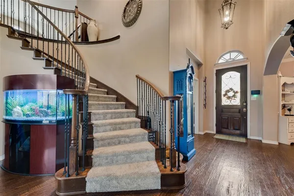 a view of entryway and hall with wooden floor