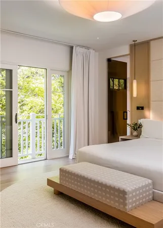 a bedroom with a large bed and a large window