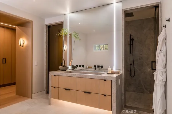 a bathroom with a double vanity sink mirror and shower