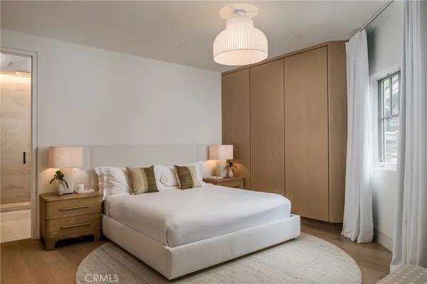 a bedroom with a bed and a chandelier