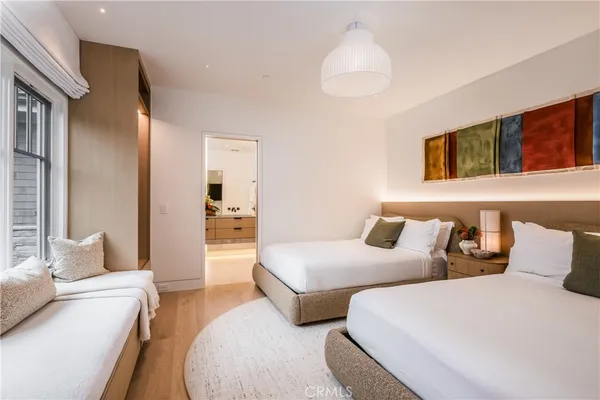 a bedroom with two beds and a chandelier