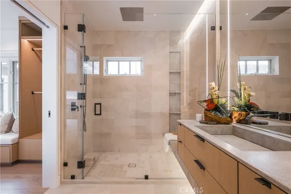 a bathroom with a tub shower vanity and a sink