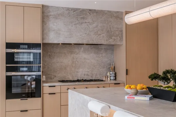 a kitchen with a sink and a stove top oven