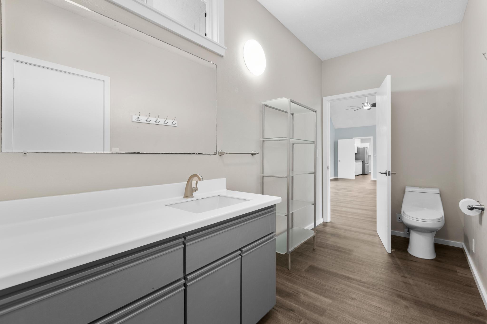 234 Kipa Street Hilo, HI 96720 - Photo 10 of 30 a spacious bathroom with a sink a toilet a shower and a window