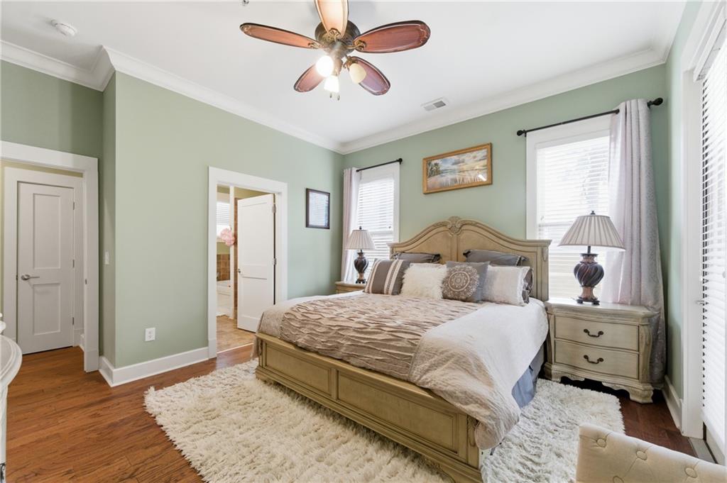 117 South Bay Road, Unit 402 Eatonton, GA 31024 - Photo 18 of 48 a bedroom with a bed and wooden floor