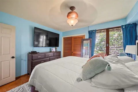a bedroom with a large bed and a flat screen tv