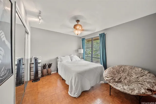 a bedroom with a bed and a chandelier