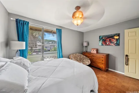 a bedroom with a bed and a large window