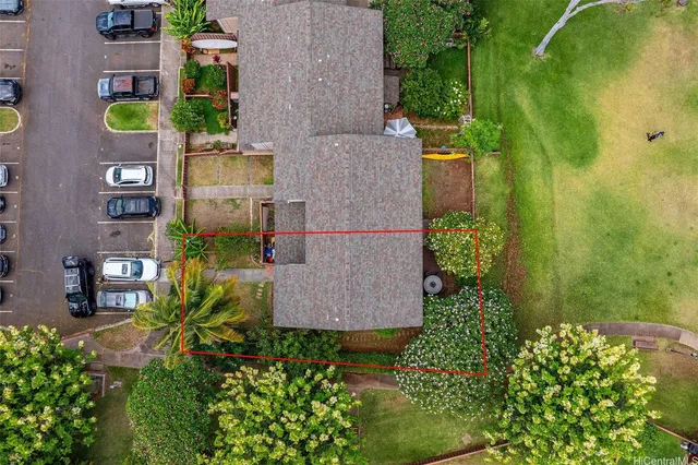 an aerial view of residential houses with outdoor space and trees all around