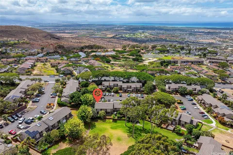 an aerial view of residential houses with outdoor space