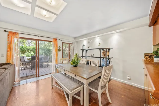 a dining room with furniture and wooden floor