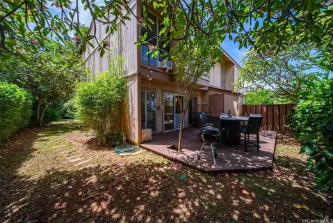 a view of a house with backyard porch and sitting area