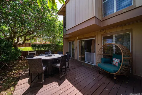 a view of a dinning table and chairs in the balcony