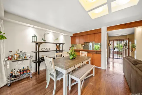 a dining room with furniture and wooden floor