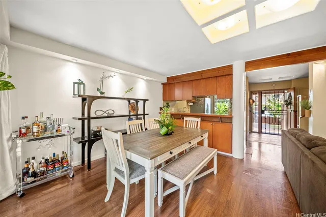 a dining room with furniture and wooden floor