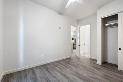 a view of an empty room with wooden floor
