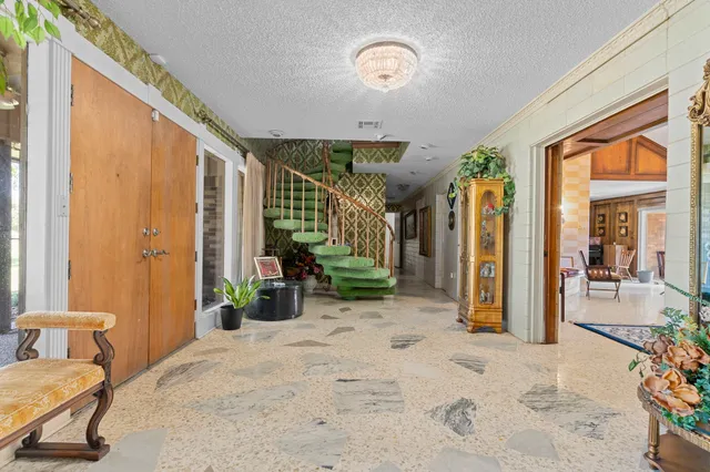 a bedroom with furniture and a large window