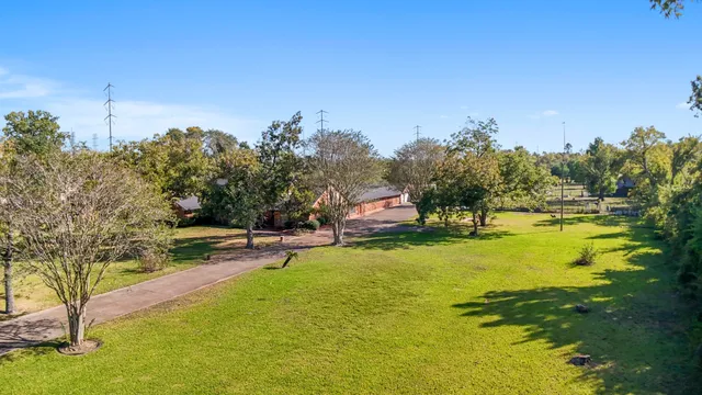 a swimming pool with trees in the background
