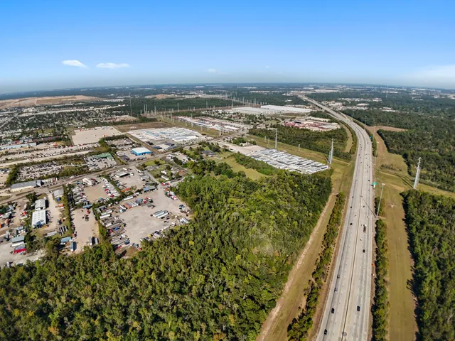 an aerial view of house with yard and mountain view in back