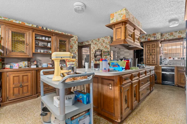 a kitchen with stainless steel appliances granite countertop a stove and cabinets