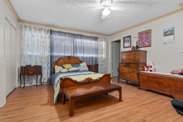 a bedroom with furniture and wooden floor