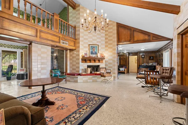 a living room with fireplace furniture and a chandelier