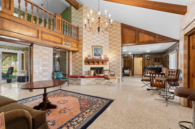 a living room with fireplace furniture and a chandelier