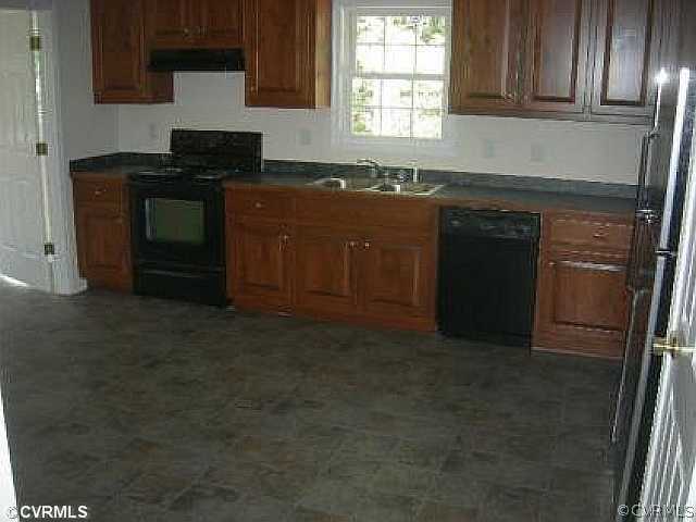 19 Winding Ridge Way Bumpass, VA 23024 - Photo 4 of 12 a kitchen with granite countertop a stove top oven microwave and cabinets