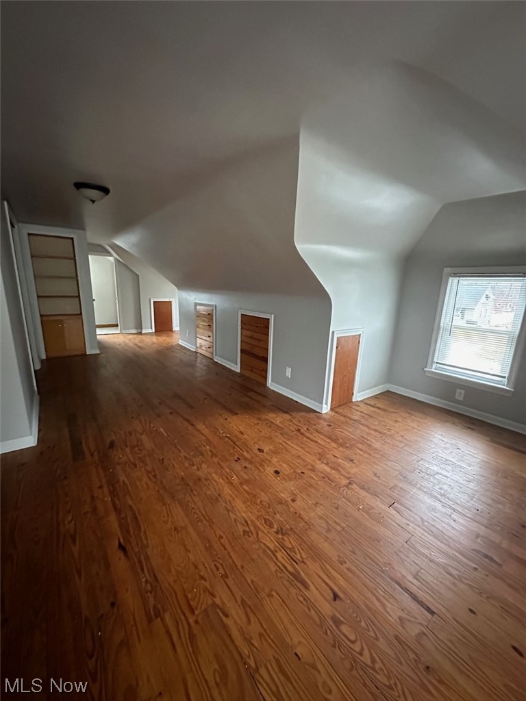 4994 North Barton Road Cleveland, OH 44124 - Photo 11 of 28 Additional living space with vaulted ceiling and dark wood-type flooring