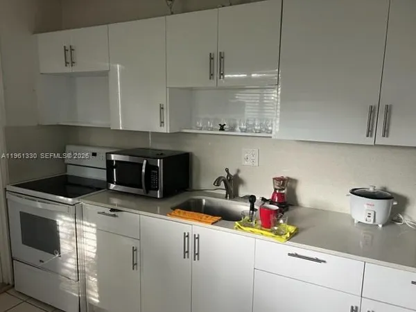 a kitchen with stainless steel appliances granite countertop a sink and a stove