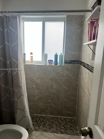a bathroom with a shower and a toilet