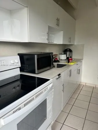 a kitchen with a cabinets and white appliances