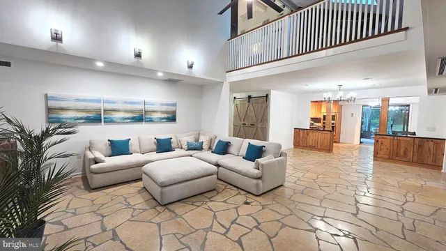 a living room with patio furniture and a floor to ceiling window