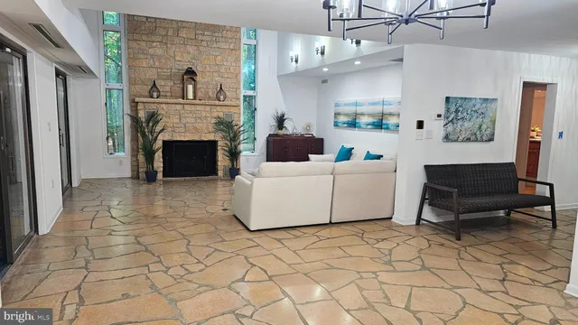 a living room with furniture a rug and a flat screen tv