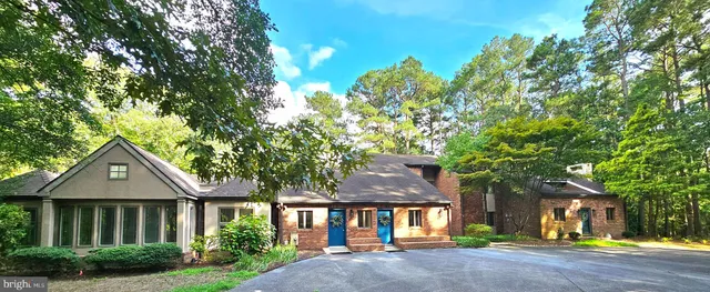 an aerial view of a house with yard and garden