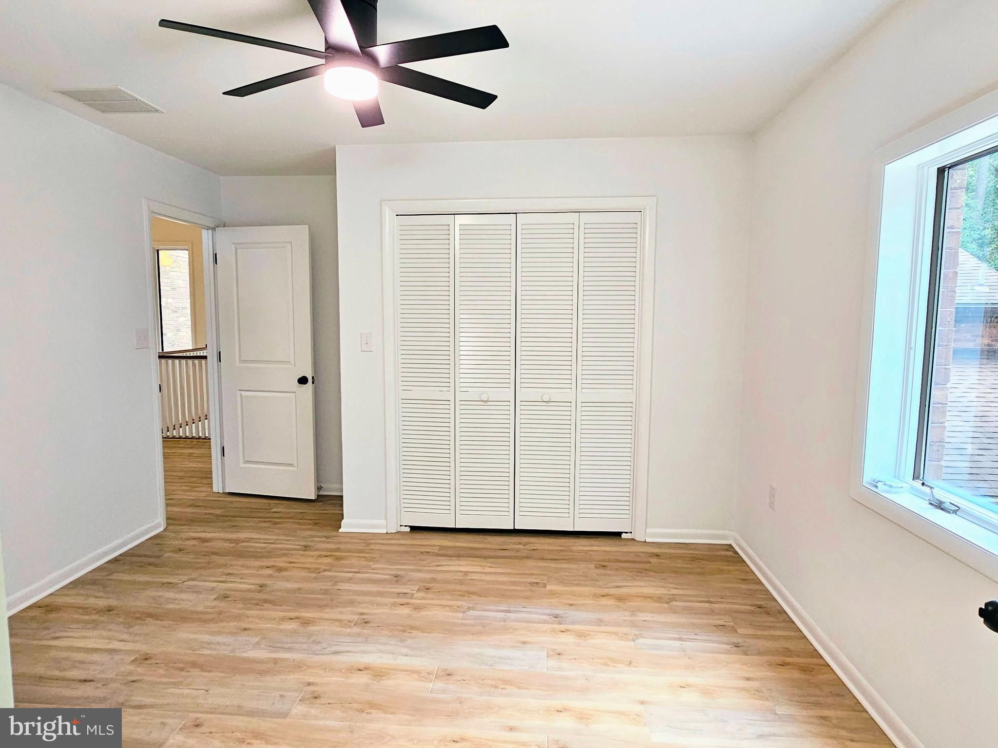 4419 Cooper Road Eden, MD 21822 - Photo 68 of 146 an empty room with wooden floor cabinet and windows