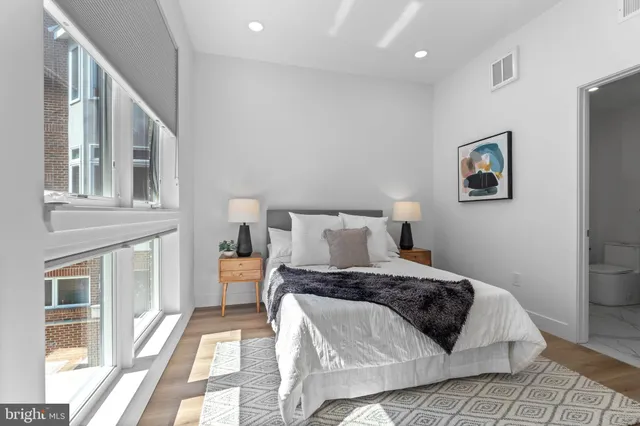 a bedroom with a bed and a large window