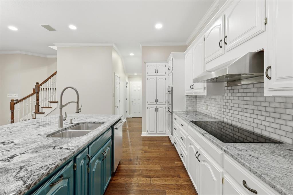 848 Birdsong Bedford, TX 76021 - Photo 11 of 40 a large kitchen with granite countertop a sink and a refrigerator