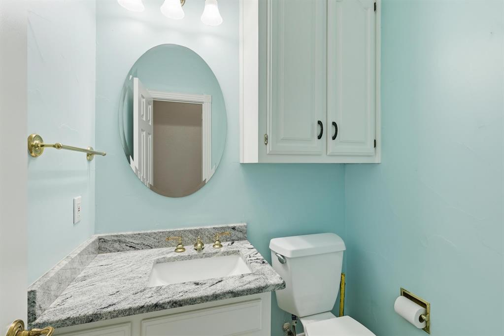848 Birdsong Bedford, TX 76021 - Photo 16 of 40 a bathroom with a granite countertop toilet sink and mirror