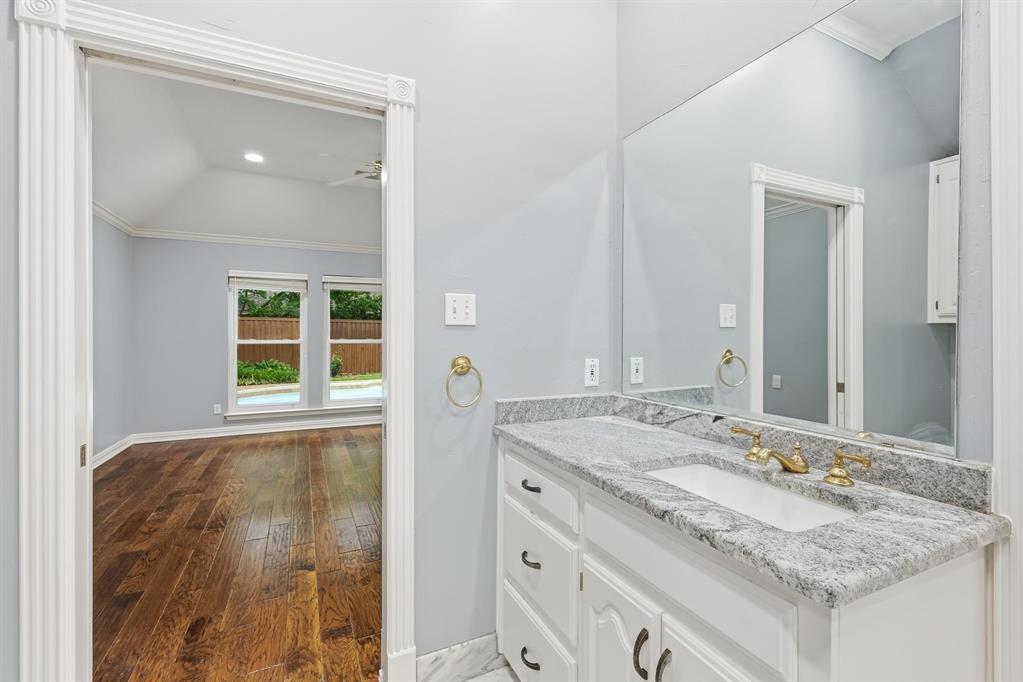 848 Birdsong Bedford, TX 76021 - Photo 24 of 40 a bathroom with a granite countertop sink and a mirror