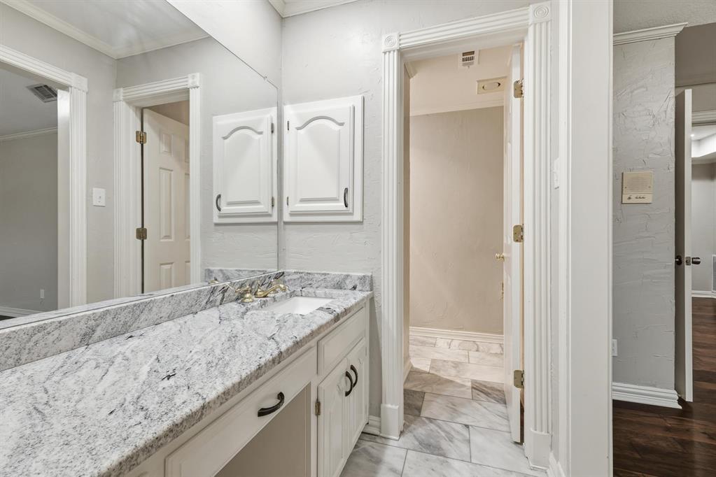 848 Birdsong Bedford, TX 76021 - Photo 31 of 40 a bathroom with a granite countertop sink and a mirror