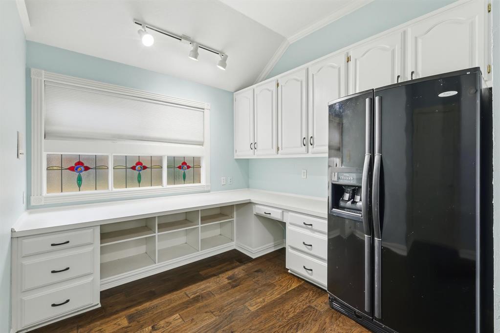 848 Birdsong Bedford, TX 76021 - Photo 37 of 40 a kitchen with a refrigerator and white cabinets