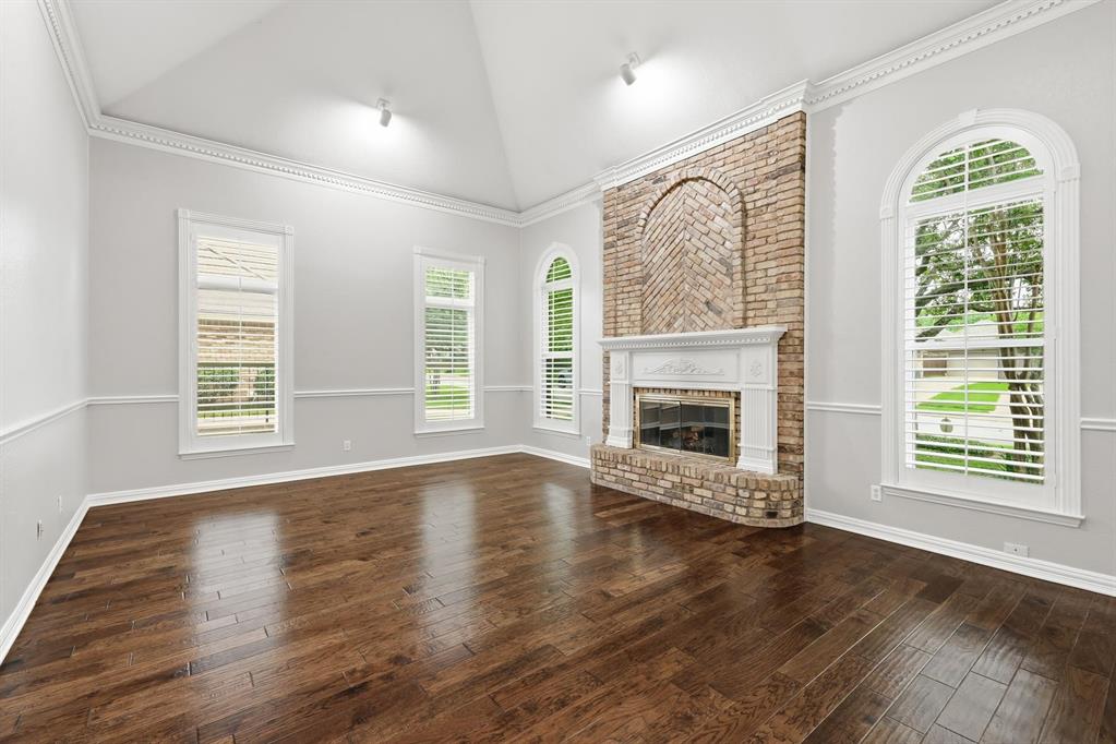 848 Birdsong Bedford, TX 76021 - Photo 5 of 40 an empty room with wooden floor fireplace and windows